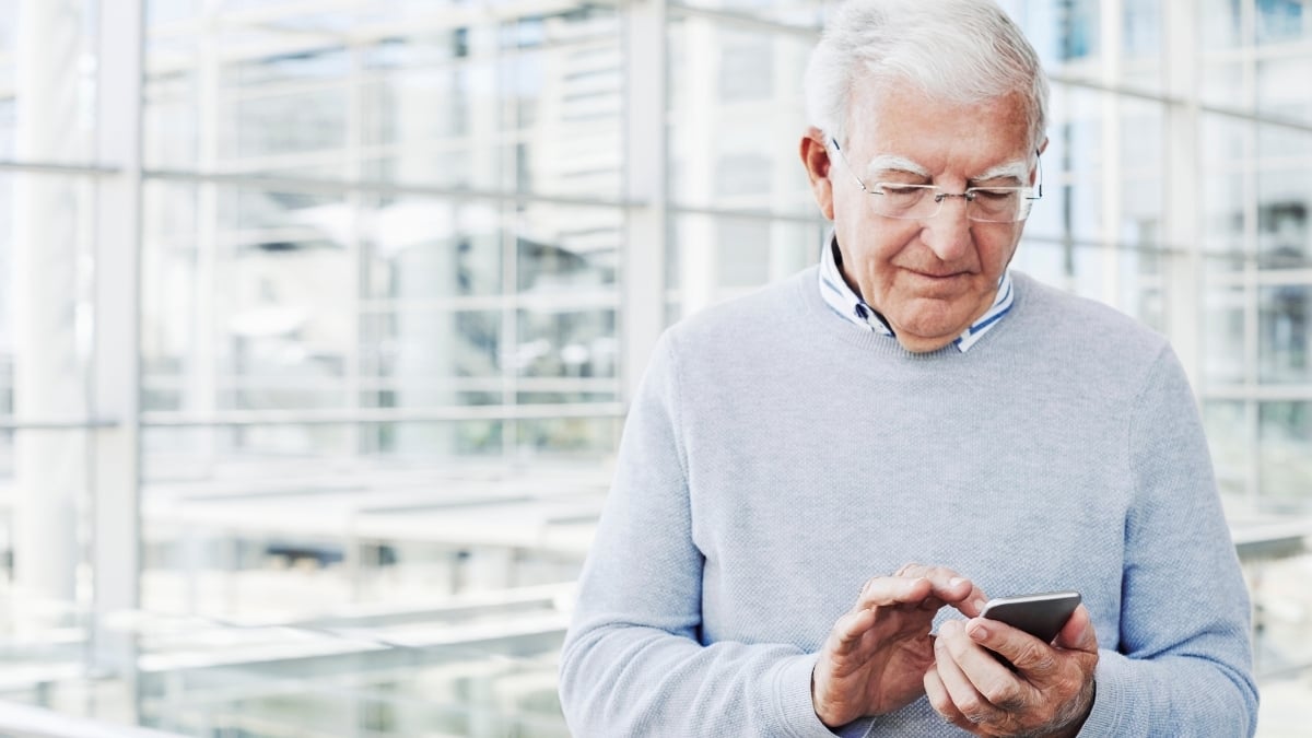 Senior texting on his phone.