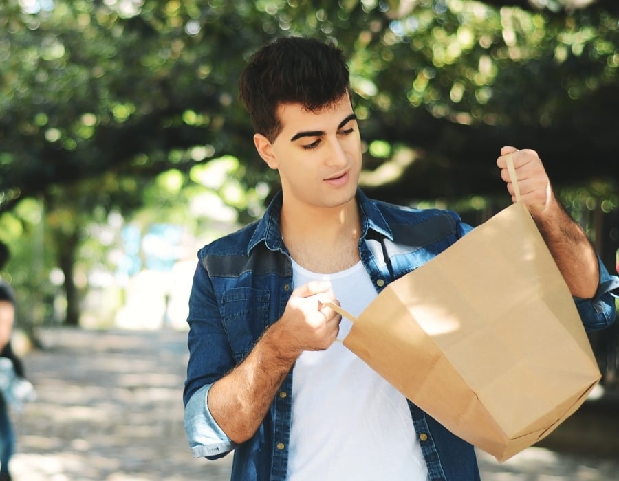 Michael holding a bag, assisting his mother in managing her conditions.
