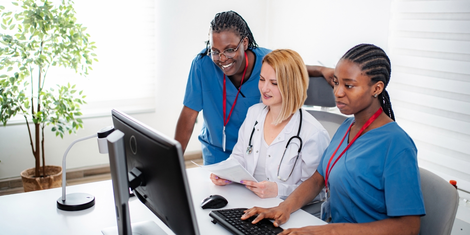 Clinicians gathered around a computer