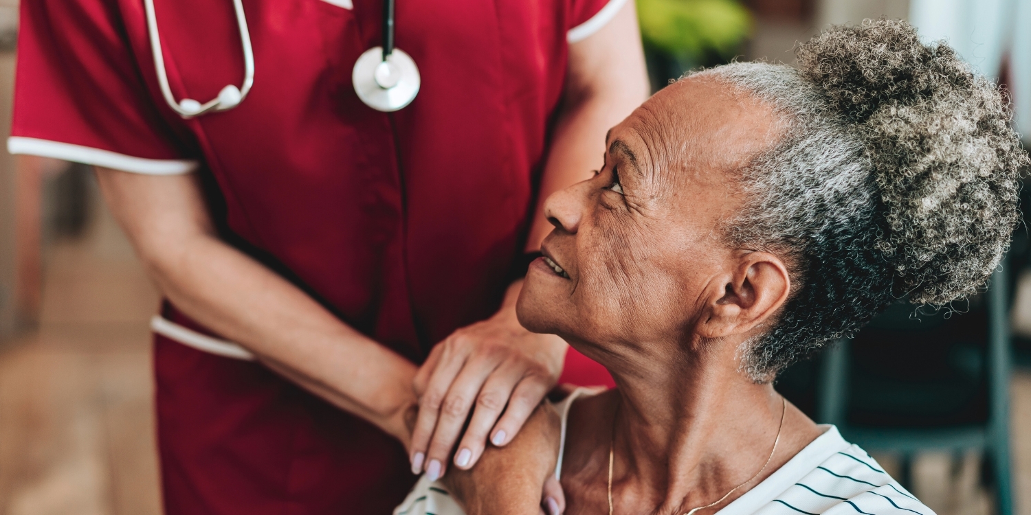 Patient looking up at a home health caregiver