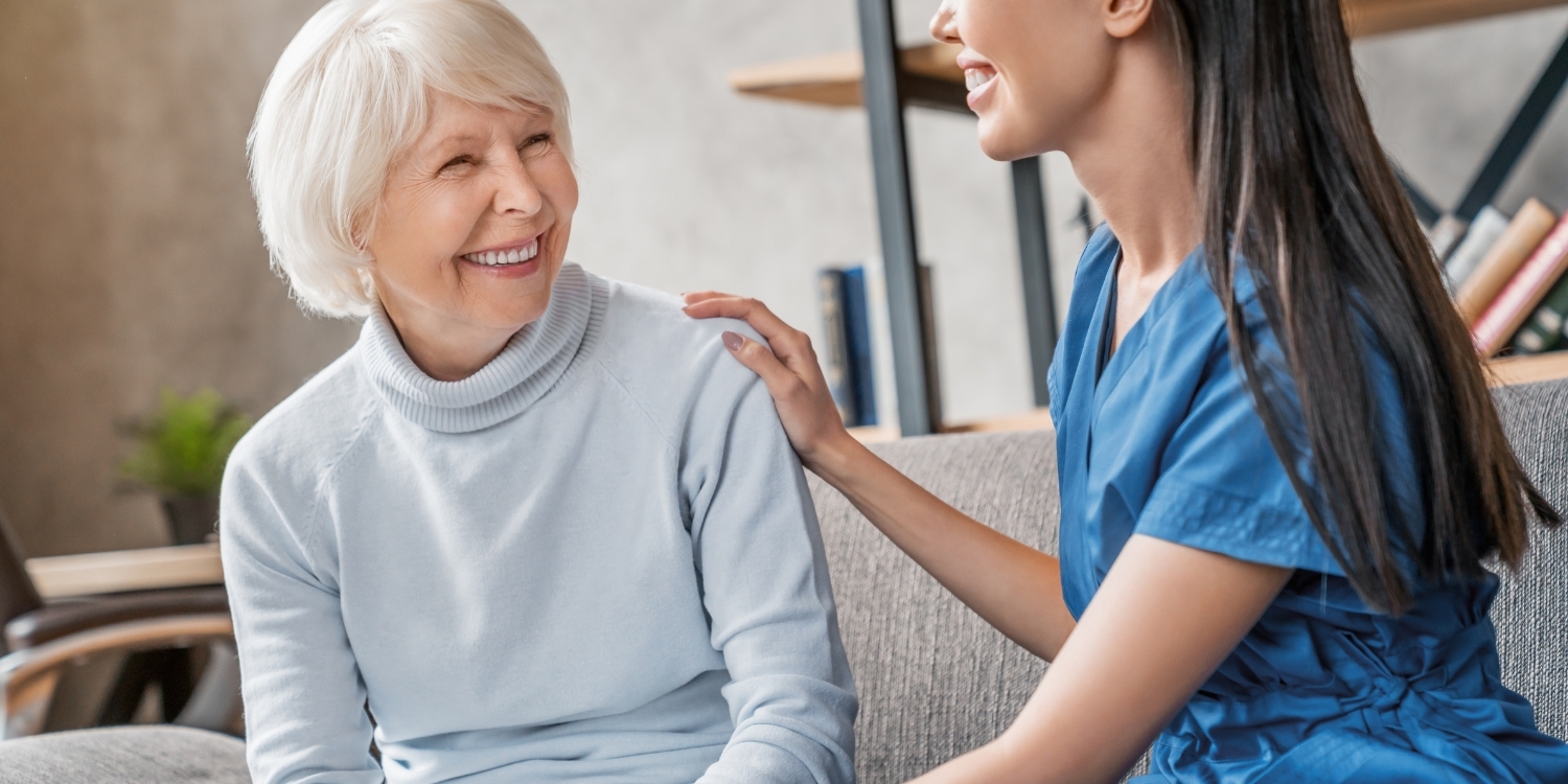 Patient sitting on couch with Home Health Nurse