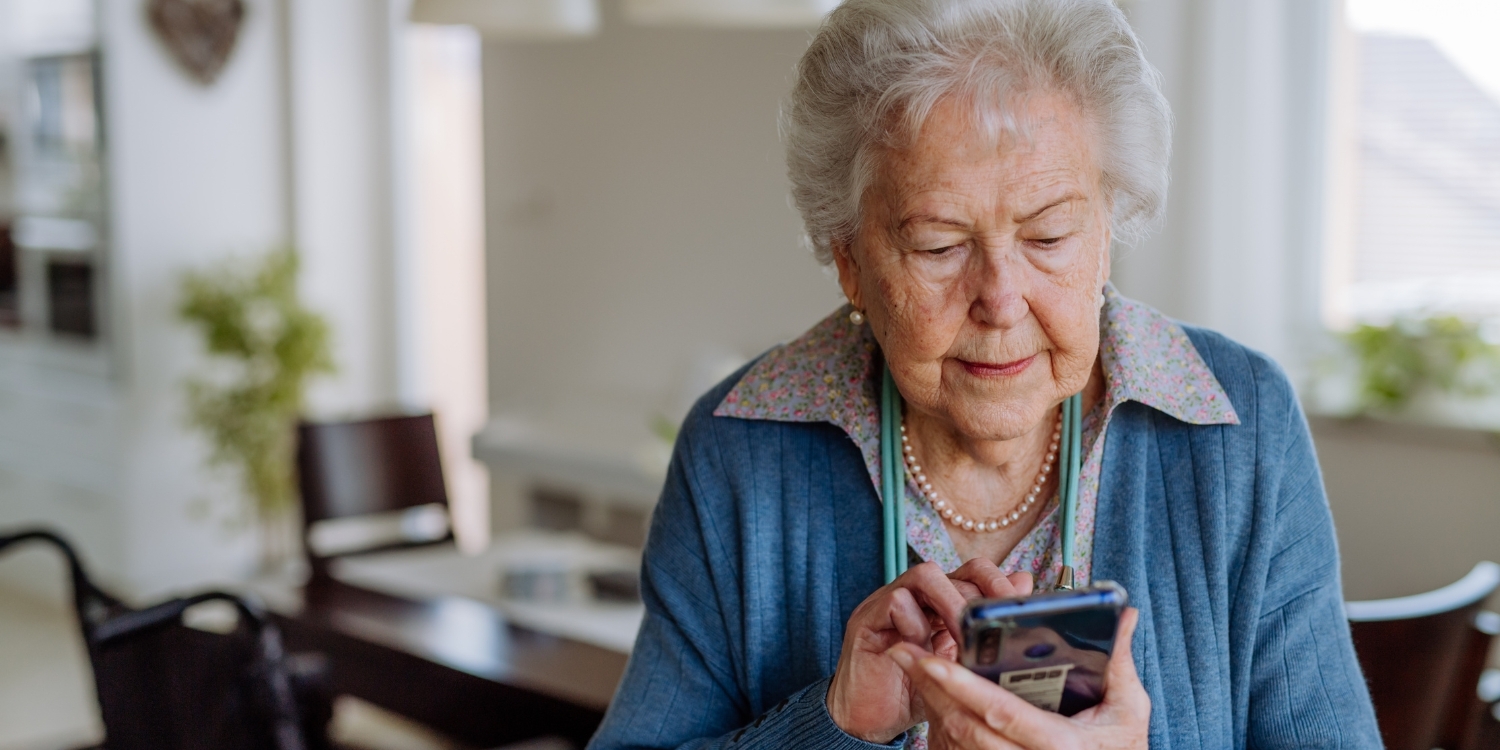 Elderly woman texting on smartphone