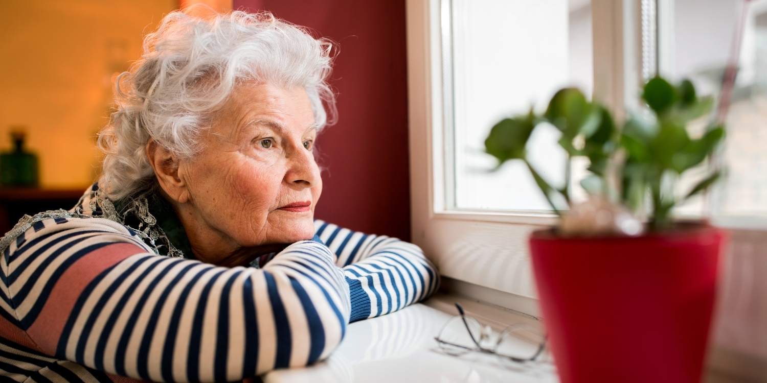 elderly woman looking out window