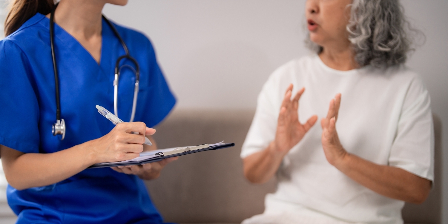 Home health clinician speaking to senior patient